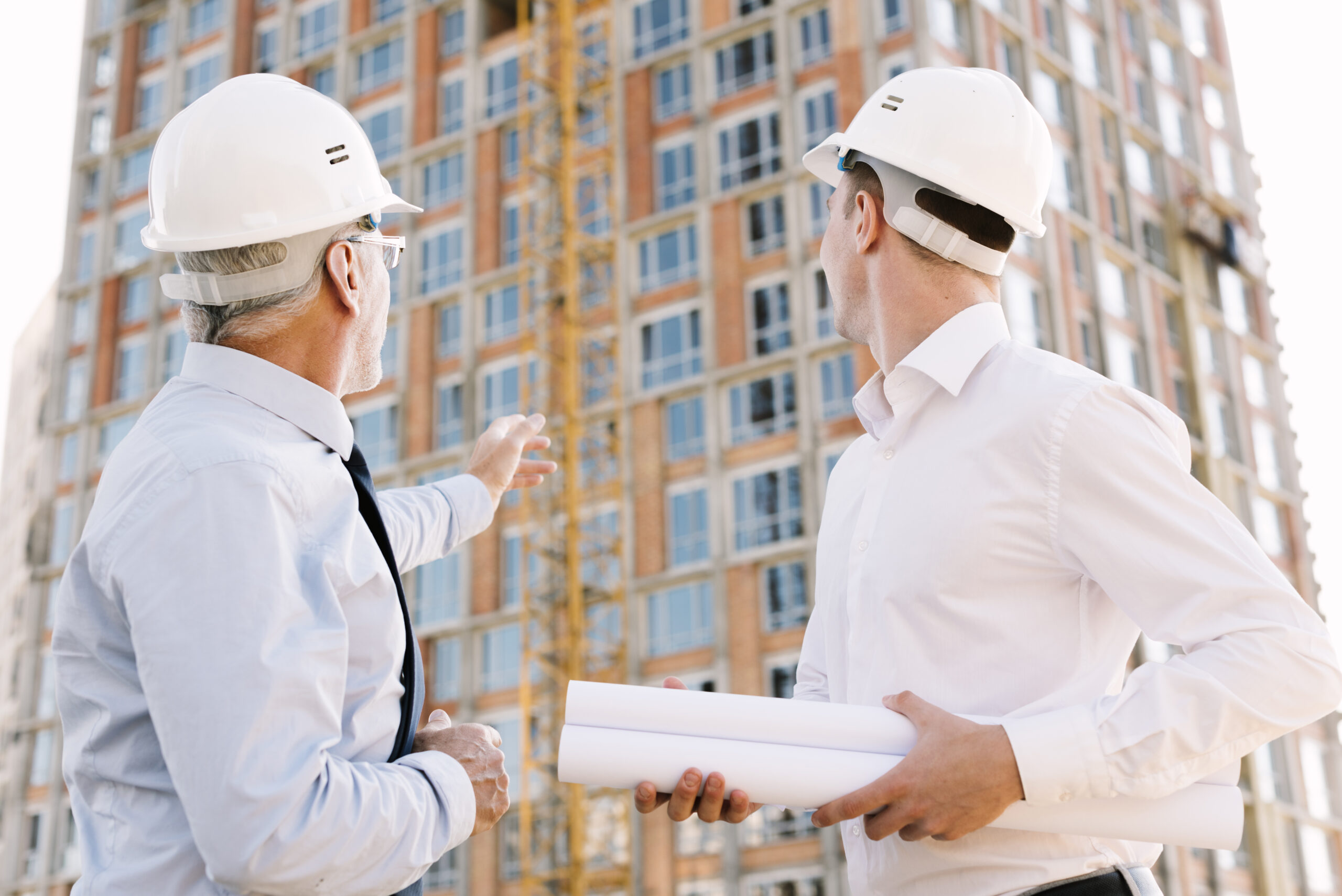 Article & News 5 low angle people with helmets looking scaffolding design scaled